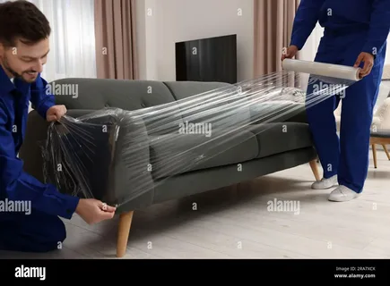 Residential furniture delivery truck unloading household furniture at a home in New Zealand