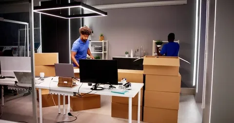 Corporate office relocation moves featuring coordinated packing, secure transportation, workspace setup, and employees transitioning to a new office location.
